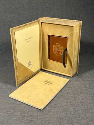 an open book with a picture of a coat of arms on it
