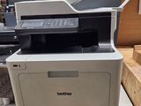a white printer sitting on top of a counter in a store
