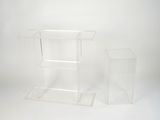 two clear acrylic stands on a white surface with a white background