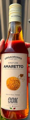 someone is holding a bottle of amarretto in their hand