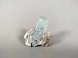 a close up of a piece of rock with a crystal on it