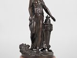 a bronze statue of a woman holding a basket of flowers