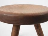 a small wooden stool with two wooden legs on a white background