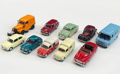 several toy cars are lined up in a row on a white surface