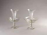 two clear glass vases sitting on a table