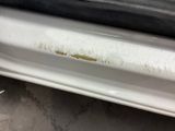a close up of a car door handle with rust on it