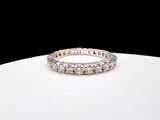 a close up of a diamond ring on a white surface