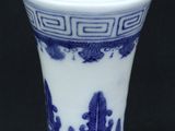 a blue and white vase sitting on a table