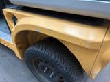 a close up of a yellow vehicle with the door open