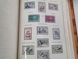 an open book with stamps on it sitting on a table