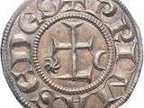 a close up of a coin with a cross on it