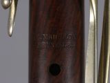 a close up view of a wooden instrument with a metal handle