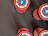 six red and white captain america buttons on the floor