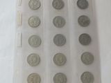 a lot of coins in a plastic case on a table