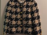 a black and white jacket hanging on a wall