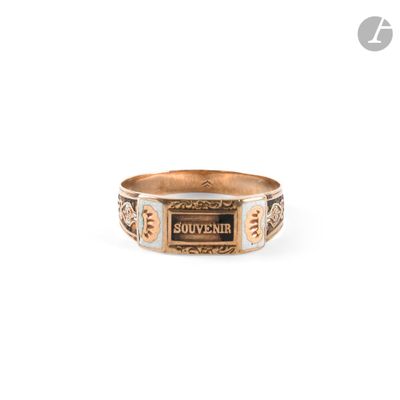 a close up of a gold ring with a sign on it