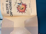 a person holding a piece of paper with a comic book inside of it