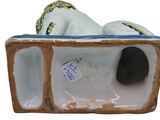 a figurine of a man and a woman laying in a box