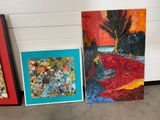 three paintings of different shapes and sizes are on display in a room