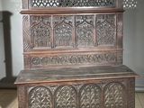 a wooden bench with carvings on it in a room