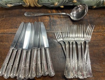 a lot of forks and spoons on a table
