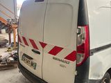 a white van with skis on top of it in a garage