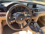 the interior of a bmw car with a steering wheel and dashboard controls