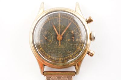 a watch that is sitting on a white surface