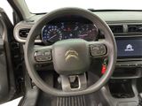 the interior of a car with a steering wheel and dashboard controls