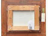 an old picture frame with a tag attached to it