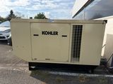 a small generator that is sitting in the parking lot