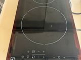 a black stove top with two burners on top of it