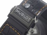 a close up of a watch on a white surface