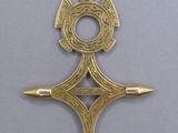 a close up of a gold pendant with a cross on it