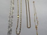 several different types of necklaces and bracelets laid out on a table