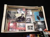 a wooden box filled with cds and cds on a table
