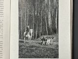 an open book with a picture of a man riding a horse and a dog
