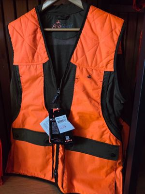 an orange vest with a tag on it hanging in a closet