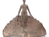 an image of a sculpture of a woman sitting on top of a rock