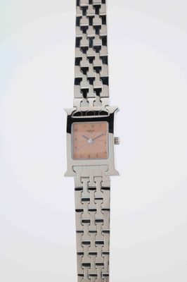 a close up of a watch on a white surface with a white background