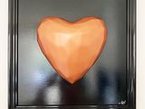 a picture of a painting of a heart in a black frame