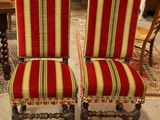 une paire de chaises à rayures rouges dans une pièce où se trouve un tapis au sol