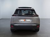the rear of a silver suv parked in a white room