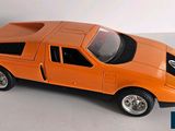 an orange toy car that is sitting on a table