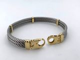 a cable bracelet with two gold clasps on a white surface