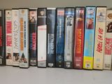 many dvd ' s lined up on a shelf next to each other