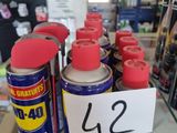 many cans of paint on a glass shelf in a store