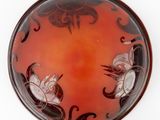 a red plate with black and white designs on it
