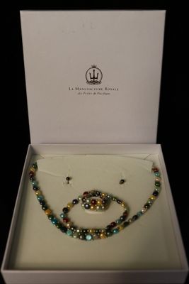 necklace and bracelet in a white box with a black background