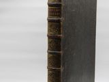 an old book sitting on top of a table next to a white background